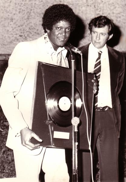 9XL.jpg - Dobie accepting a Platinum disc for his Infinity Album, “Midnight Diamond,” from Peter Gallo of Gallo Records, Johannesburg, South 
Africa – late-70s.